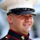 Smiling U.S. Marine in dress uniform cap
