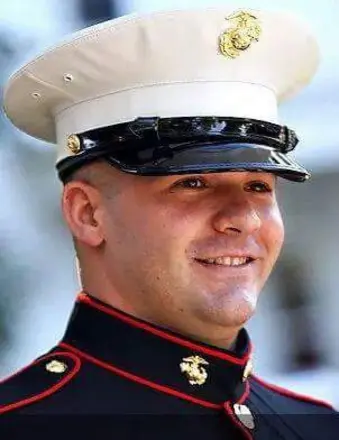 Smiling U.S. Marine in dress uniform cap