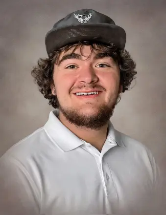 Young man in cap smiling in studio portrait