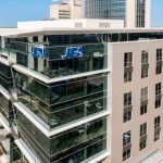 Modern glass office building with JEA logo — JEA canceled land deal investigation — JEA land deal investigation