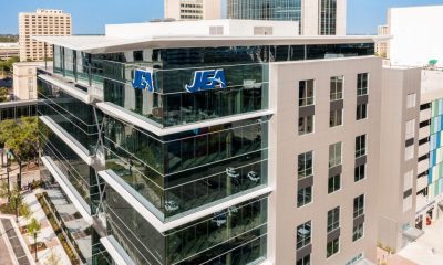 Modern glass office building with JEA logo