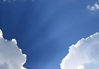 Blue sky with white clouds and sun rays