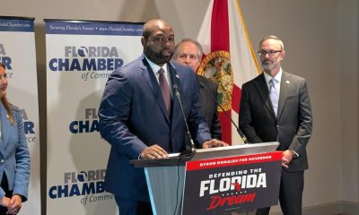 Man speaking at Florida campaign event podium