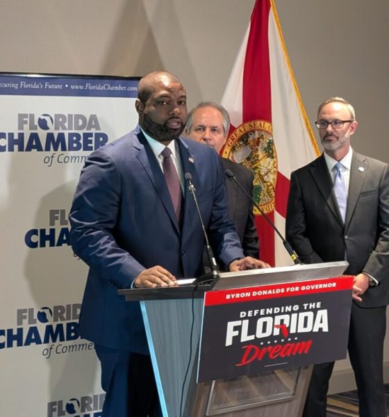 Man speaking at Florida campaign event podium