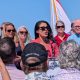 Woman speaking at outdoor political rally podium