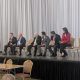 Panel discussion with six speakers on stage