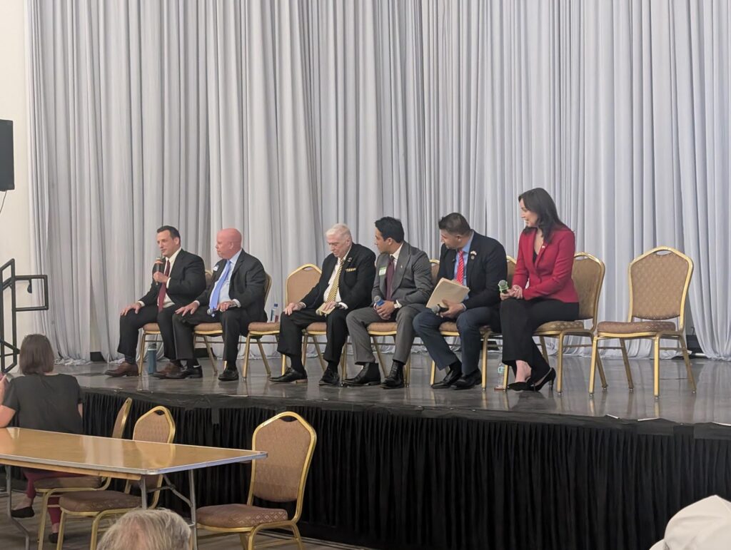 Panel discussion with six speakers on stage