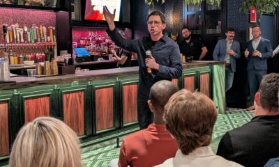 Man speaking with microphone at bar event