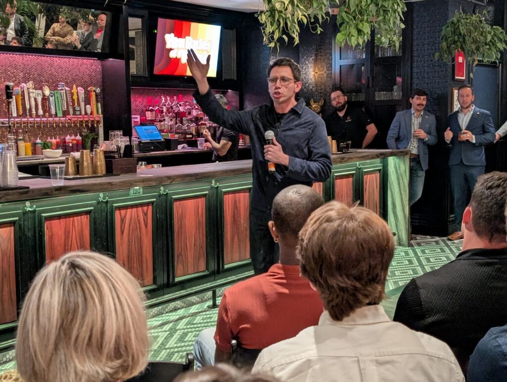 Man speaking with microphone at bar event