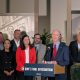 Man speaking at podium with antisemitism sign