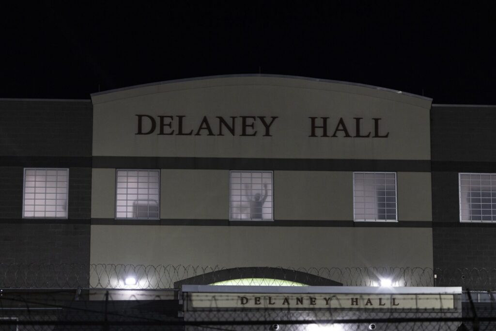 Delaney Hall building at night with lit windows
