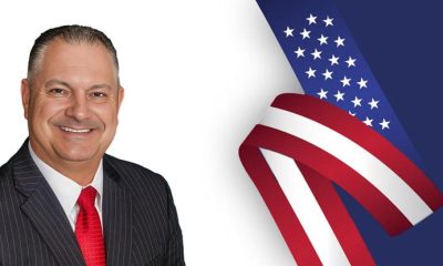 Man in suit with American flag background