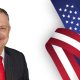 Man in suit with American flag background