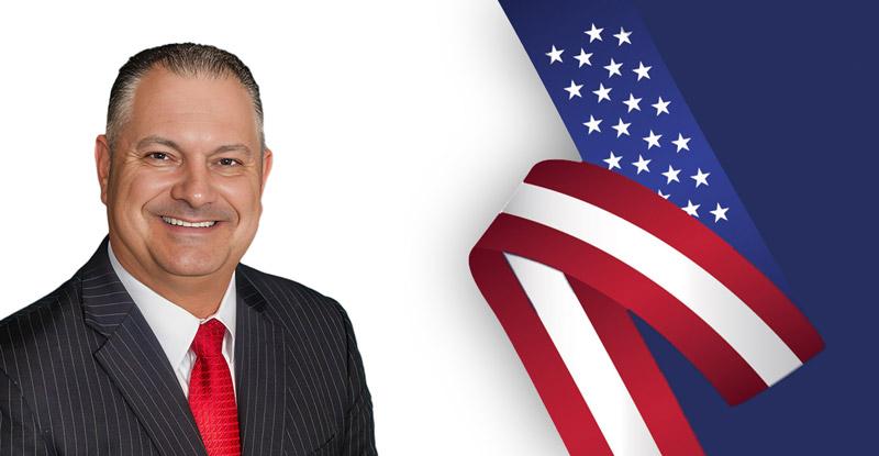 Man in suit with American flag background