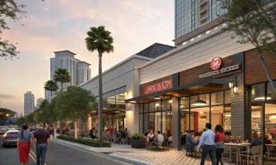 Outdoor dining along palm-lined city street at sunset