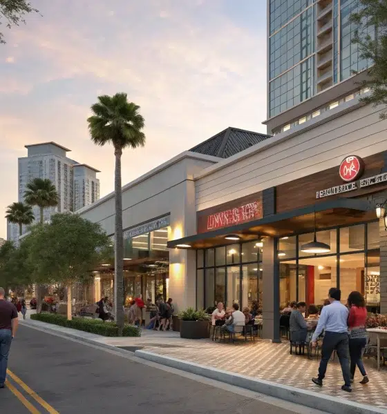 Outdoor dining along palm-lined city street at sunset