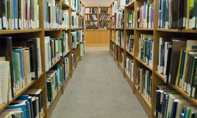 Library aisle lined with bookshelves