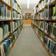 Library aisle lined with bookshelves