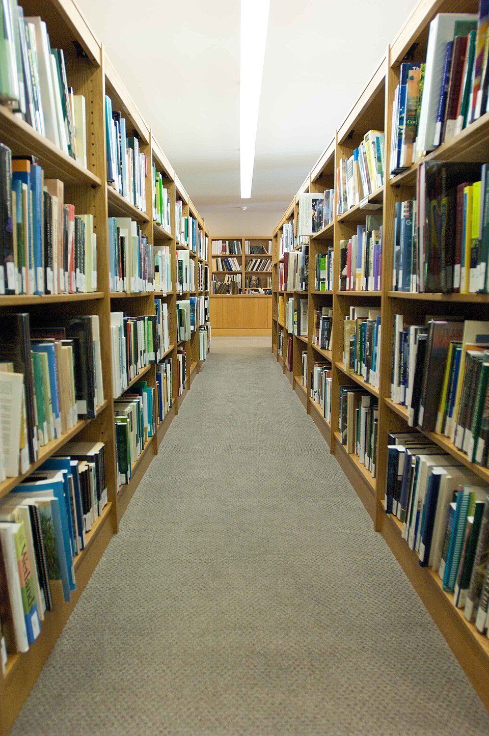 Library aisle lined with bookshelves
