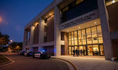 Police cars outside county courthouse at dusk