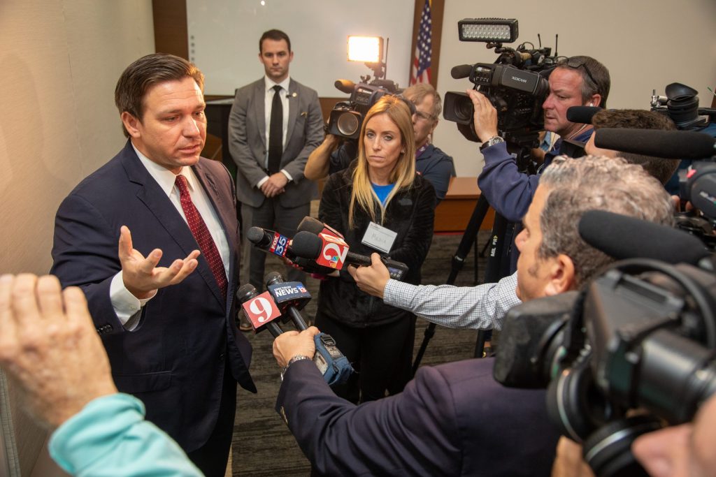 Politician speaking to reporters at press conference