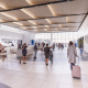 Modern airport security checkpoint with travelers walking