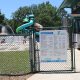 Entrance gate to Roger Scott Pool with slides