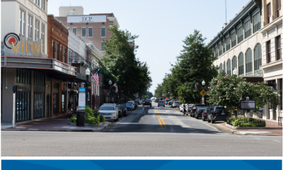 Downtown Pensacola street with survey banner