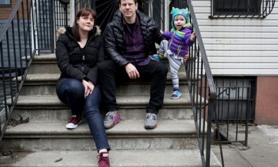 Family sitting on urban stoop with toddler