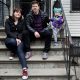 Family sitting on urban stoop with toddler