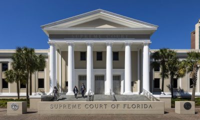 Florida Supreme Court building with columns and palm trees