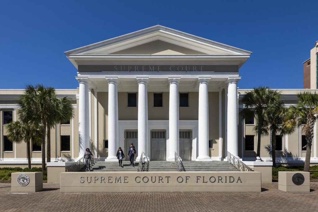 Florida Supreme Court building with columns and palm trees