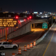 Highway exit closure sign at night with cones