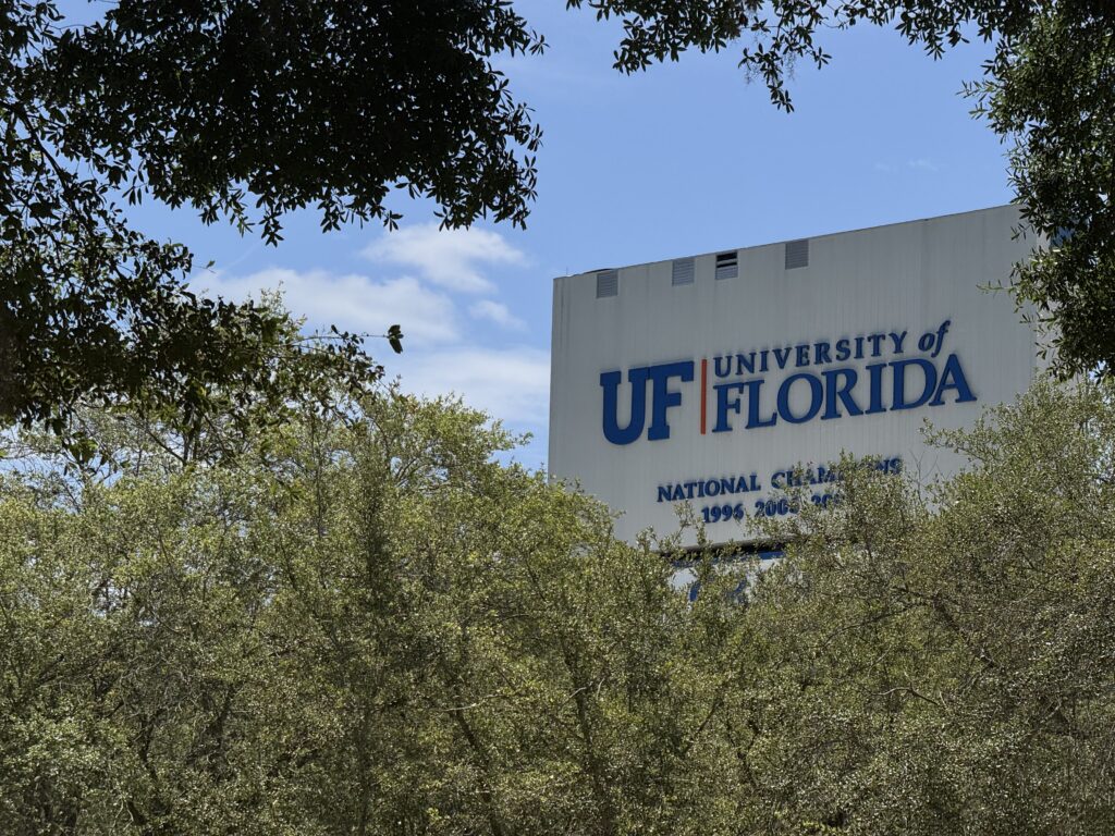 University of Florida sign behind trees
