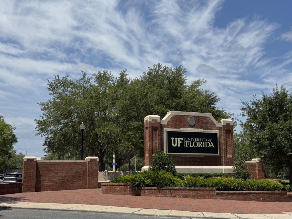 University of Florida entrance sign on brick wall
