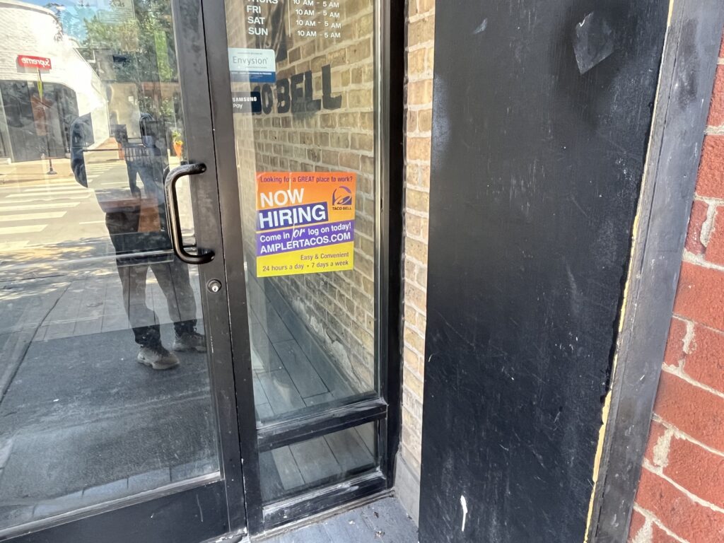 Taco Bell door with Now Hiring sign