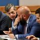 Men in suits discussing at conference table