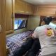 Woman assisting person lying on RV bed