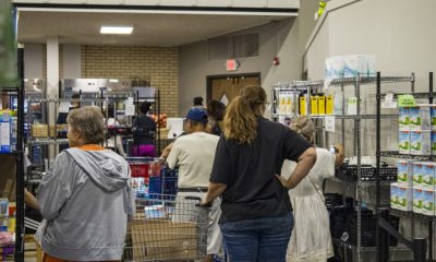 People shopping at community food pantry shelves