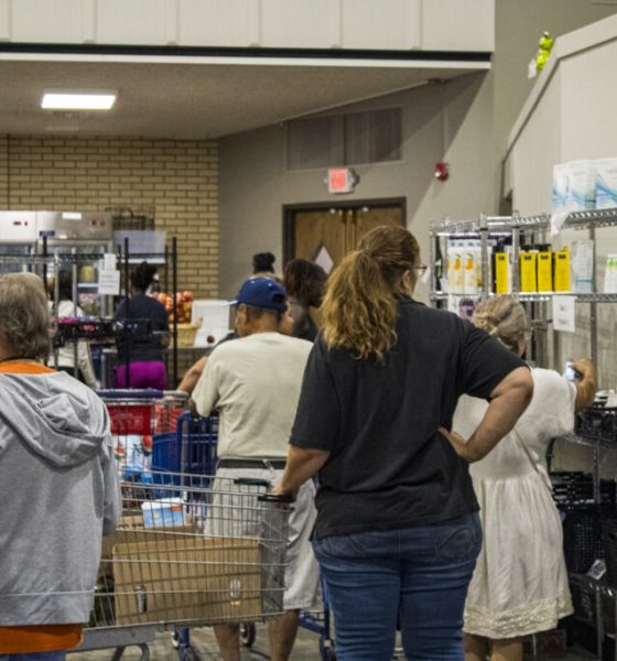 People shopping at community food pantry shelves — food insecurity in Pensacola — Pensacola food insecurity