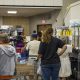 People shopping at community food pantry shelves