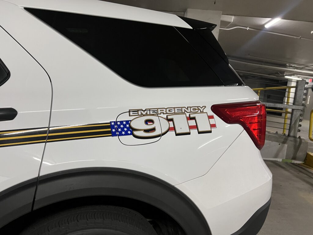 Emergency 911 decal on white SUV