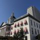 Historic capitol building with red striped awnings