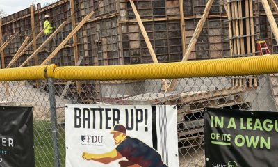 Construction site behind fence with advertising banners
