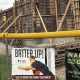 Construction site behind fence with advertising banners