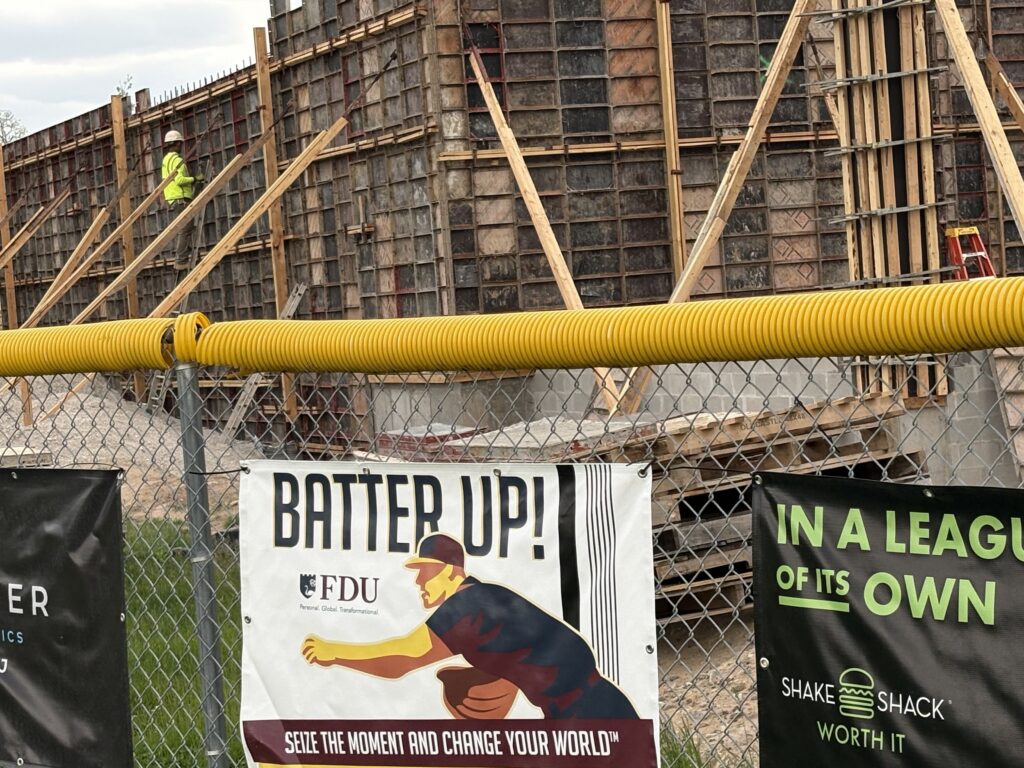 Construction site behind fence with advertising banners