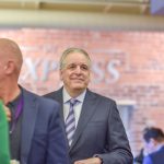Man in suit at indoor networking event — florida medicaid work requirements lawsuit