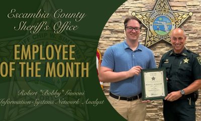 Sheriff presenting Employee of the Month certificate