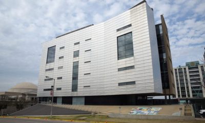 Modern white building with narrow windows and raised base