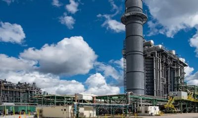Industrial power plant with large smokestack and pipes